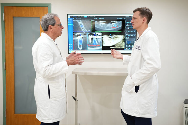 Oral Surgeons Drs. Philip & Brian Bhaskar reviewing xrays